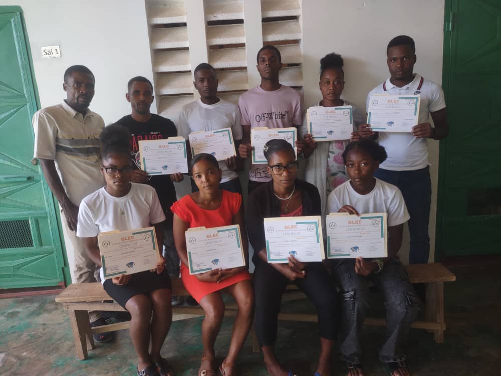 Students holding their GLEC certificates at the Georgette Beauvais School